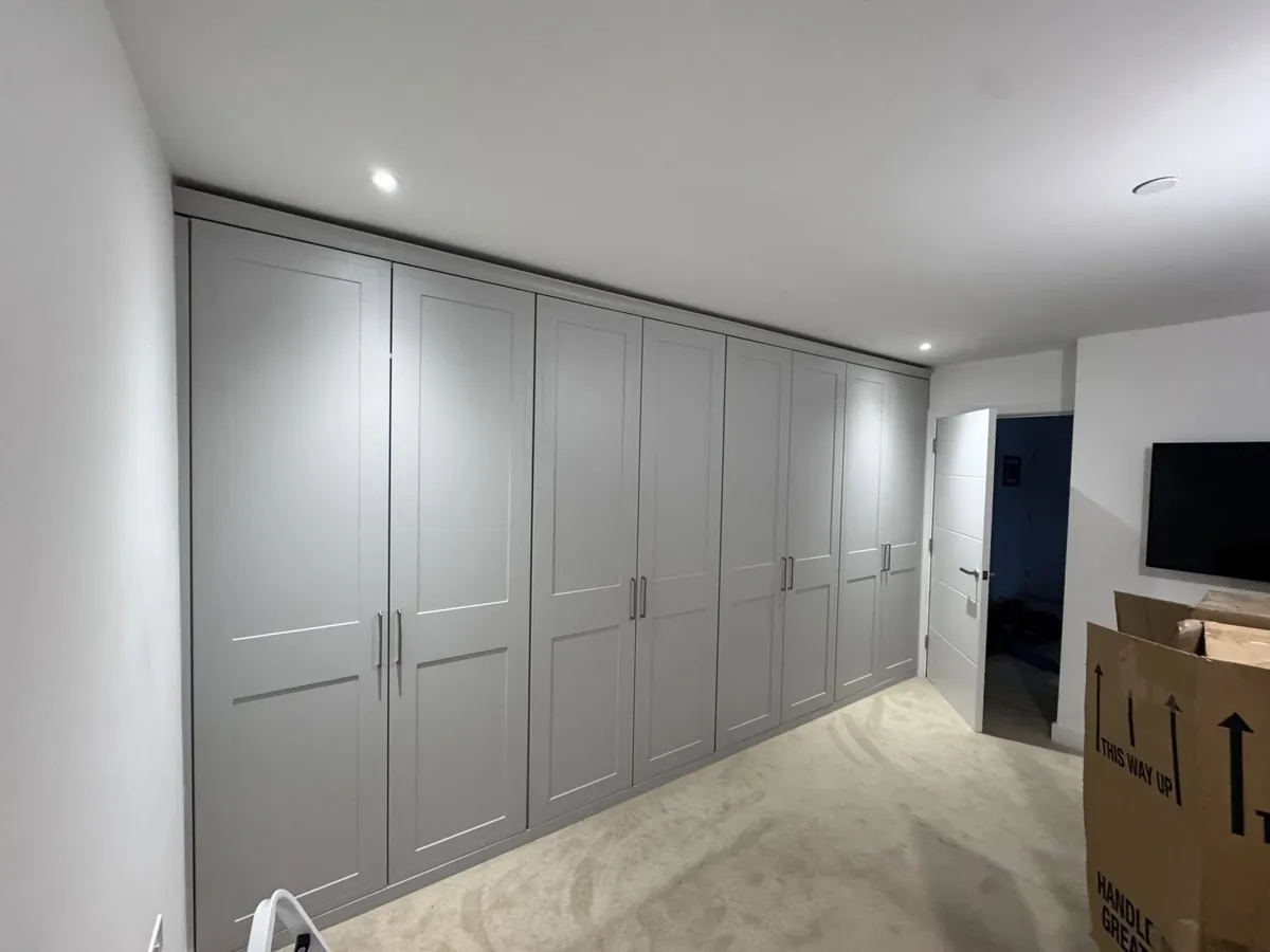 A run of grey shaker fitted wardrobes made to measure