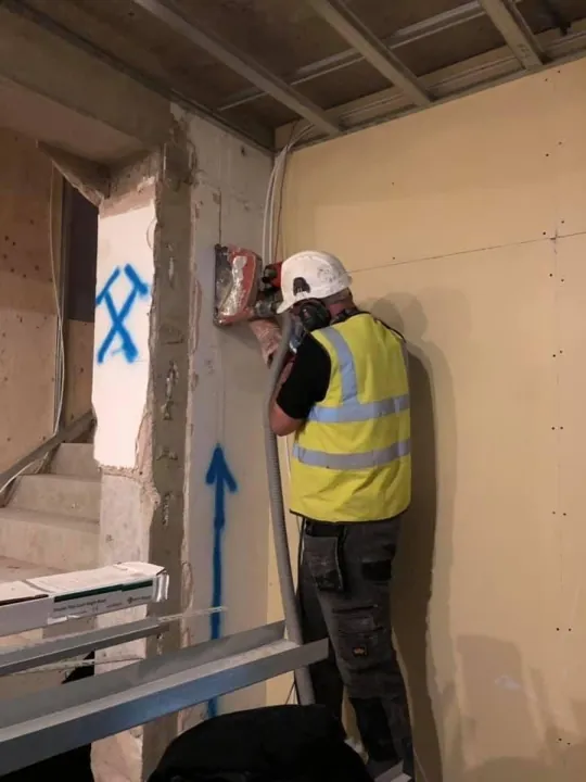 Our electrician chasing a wall for new cables during a rewire